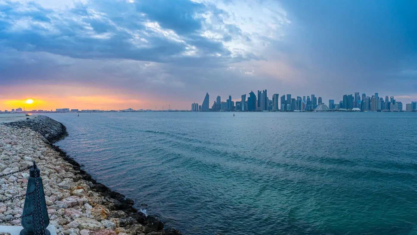 The Doha skyline across the water at sunset
