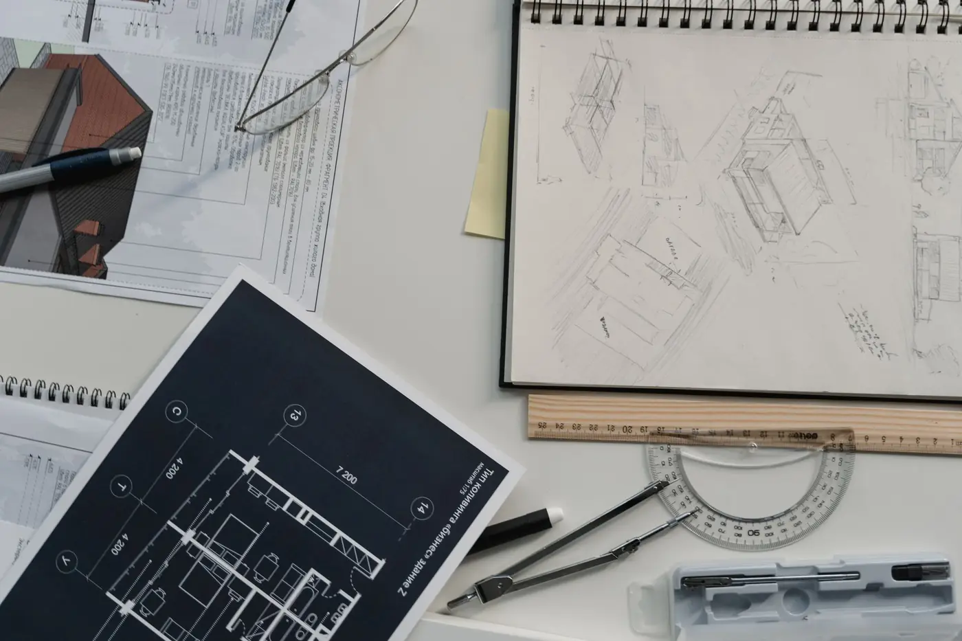 Architectural drawings and sketches spread across a desk